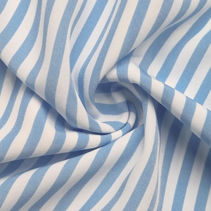 Detail shot of the blue and white vertical striped cotton fabric with smooth texture