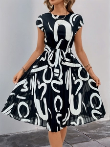 Detail of elegant black and white abstract print dress with waist tie and pleated skirt