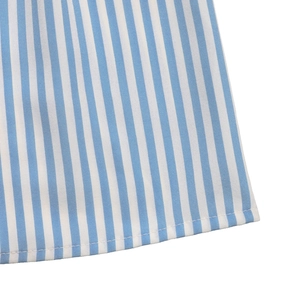 Detail of blue and white striped fabric hem with precise stitching and smooth texture