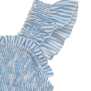 Detail of blue and white striped fabric with smocked elastic and ruffle trim