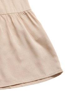 Detailed macro view of beige twill fabric featuring ruched stitching and fine hemline finish