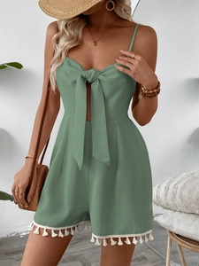 Detail of waffle textured green romper with tassels and cutout front tie knot