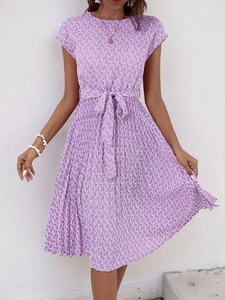 Detail of purple pleated dress with geometric print and adjustable waist tie belt