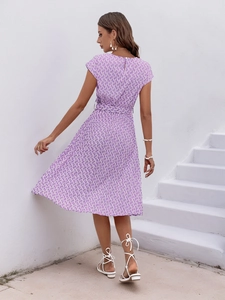 Close-up of elegant purple and white geometric scale print on pleated midi dress