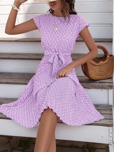 Detail of purple geometric print short sleeve pleated dress with waist tie and A-line hem