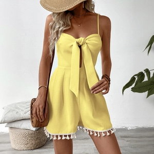 Yellow waffle knit romper with oversized front bow and white tassel fringe hem for summer
