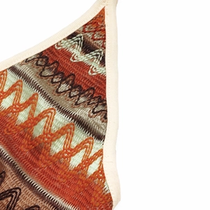 Macro detail of wave pattern knit top with orange and brown ethnic stripe texture