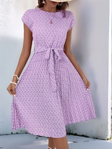Detailed view of the purple geometric pattern and waist tie on the pleated A-line dress