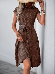 Close-up detail of geometric snake print and waist tie on the pleated summer dress