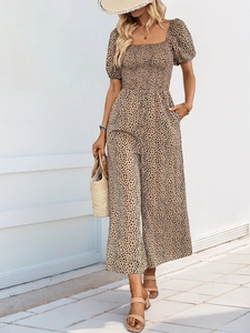 Detail of smocked leopard print jumpsuit with square neck and puffed short sleeves