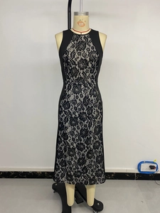 Detail of elegant black sleeveless sheath dress with floral lace panel on the mannequin