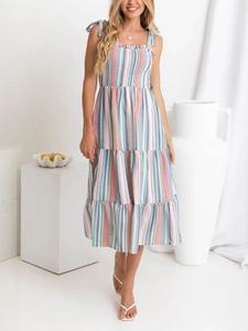 Detail view of the colorful striped smocked bodice and adjustable bow tie straps