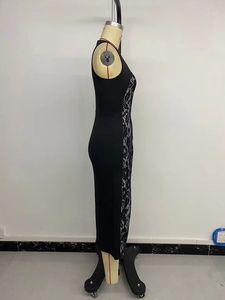 Detail of elegant black sleeveless midi dress with white floral lace side panel inserts