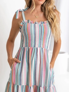Detail of colorful striped summer dress with smocked bodice and ruffled neckline