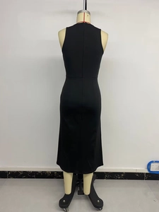 Detail of the back of a black sleeveless midi dress showing a long invisible zipper closure