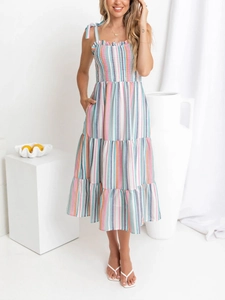 Detail of colorful striped maxi dress with tiered skirt and ruffled bow straps