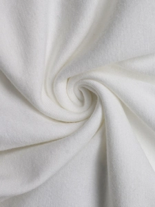 Macro shot of white ribbed knit cotton fabric showing soft texture and breathable weave