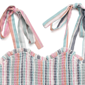 Detail of colorful striped dress with smocked bodice and adjustable tie straps