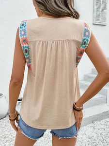 Detailed back view of sleeveless top with colorful crochet trim and pleated design