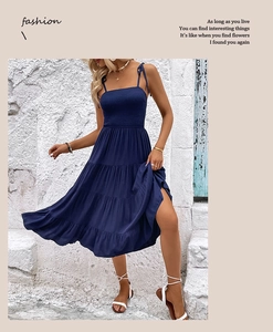 Detail of navy blue tiered sundress with shirred bodice and bow shoulder straps