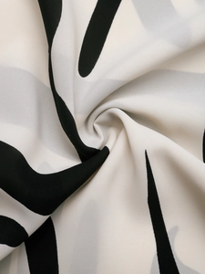 Detailed macro view of black and white geometric pattern on lightweight chiffon fabric