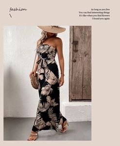 Detail of tropical palm leaf print strapless jumpsuit with waist tie and wide-leg design