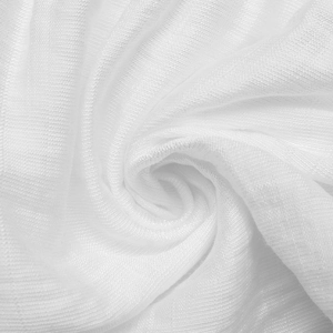 Close-up of white ribbed knit fabric texture showing soft drape and sheer material