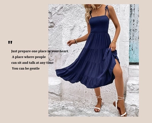 Detail of navy blue tiered sundress featuring high slit and smocked waist design