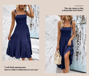 Detailed view of dark blue tiered summer dress featuring a smocked bodice and straps