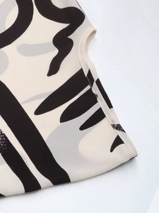 Detailed view of the black and white abstract print and smooth stitching on the armhole