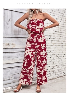 Detail of red floral print fabric on a strapless wide-leg jumpsuit for summer fashion