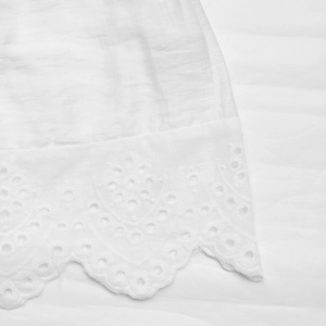 Close-up of white Y2K slim tube top featuring sheer fabric and delicate lace embroidery