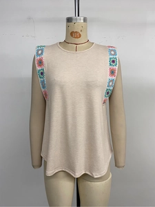 Detail of colorful crochet floral embroidery on shoulder of beige sleeveless summer top