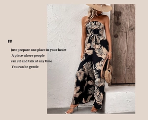 Detail of tropical leaf print strapless jumpsuit with waist tie for summer vacation wear
