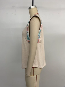 Detail of bohemian apricot sleeveless top featuring colorful crochet knit shoulder trim
