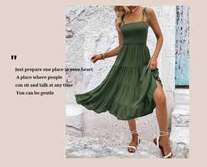 Detailed close-up of dark green tiered smocked dress showing pleated fabric texture