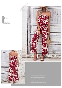 Detail view of red floral off-the-shoulder wide-leg jumpsuit with vacation accessories