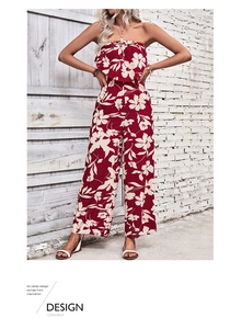Detail of burgundy floral off-shoulder jumpsuit with wide legs and ruffle neckline