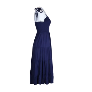 Side view of dark blue smocked A-line maxi dress with adjustable tie-up straps