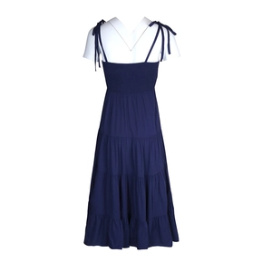 Detailed view of navy blue tiered dress with smocked bodice and adjustable shoulder straps