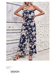 Detail of navy floral off-shoulder jumpsuit showing smocked waist and wide leg silhouette