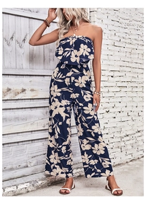 Detail of ruffle neckline and floral print on strapless wide-leg jumpsuit