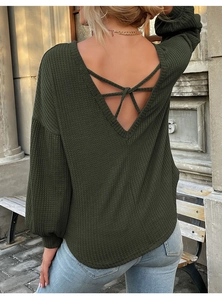 Detail of army green waffle knit top featuring a backless V-neck and cross strap design