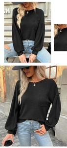 Detail view of black waffle knit texture on a long-sleeve top with chest pocket