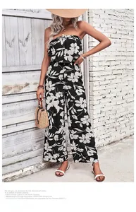 Detailed view of strapless jumpsuit with black and white floral prints and wide leg cut