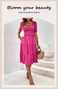 Detail of fuchsia square neck dress with smocked bodice and layered cake skirt texture