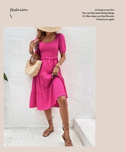 Detail of smocked elastic bodice and square neck on bright fuchsia tiered midi dress