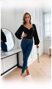 Close-up of black long sleeve bodysuit with knot v-neck detail and elegant puff sleeves