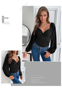 Close-up of black long sleeve bodysuit featuring a sweetheart neckline and twist knot detail