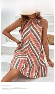 Detail of summer striped halter neck dress with ruffles on white stone stairs